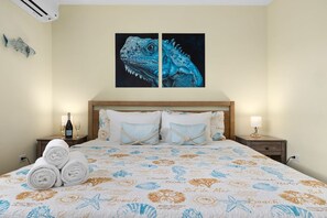 Our bedroom is designed for relaxation, featuring a luxurious bed, crisp linens, and the convenience of both AC and a TV