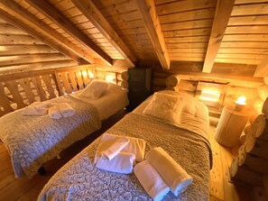 Mezzanine with three single beds and TV