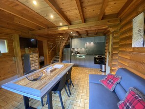 Living room with fireplace and equipped kitchen