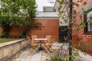 Walk into the courtyard, a green haven with alfresco furniture and a grassy yard to spread out