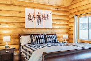 The master bedroom has a classic cozy cabin feel.