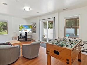 Let off some steam in the Game Room with a Foosball Table & Wet Bar!
