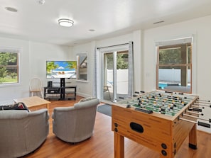 Let off some steam in the Game Room with a Foosball Table & Wet Bar!