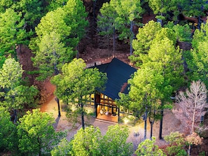 Escape to Woodsy Wonder – Your ultimate retreat surrounded by nature! Enjoy endless fun with a playset, pool table, shuffleboard, and an arcade, all tucked away in the serene beauty of the forest. Perfect for family adventures and unforgettable memories!
