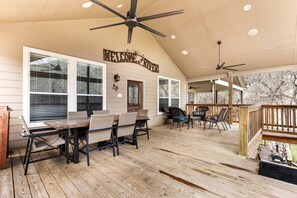 Ascend to a spacious deck with a vaulted ceiling, oversized fans, and inviting outdoor furniture – a perfect haven for relaxation.