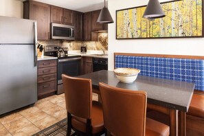 The Villa Kitchen comes with a table for 4, full refrigerator, microwave, oven, stove top, coffee maker, and dishwasher.