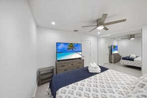 Mastering relaxation: Unwind in the exquisite master bedroom, complete with a sleek TV for the perfect escape.