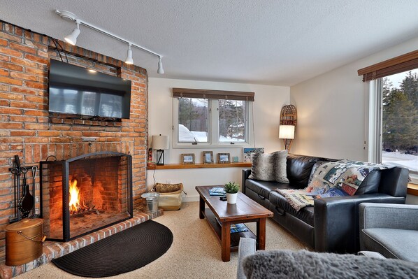 Cozy nights by the fireplace, where comfort meets style. Our living room, your sanctuary.