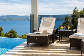 Deck charis by the hetaed pool in rental villa Holiday Residence with 4 bedrooms for 8 pax