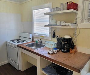 Kitchenette includes a refrigerator, stove, microwave, coffee maker, and basics.