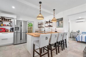 Kitchen and kitchen counter with chairs 