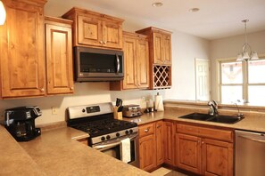 Kitchen with gas stove, dishwasher, coffee maker with kcup and standard drip. All standard kitchen amenities are included. 