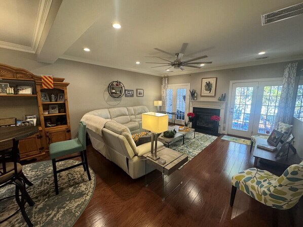 Comfortable living room with ample seating and access to back patio.