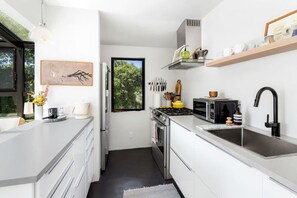 Pristine and Well-Equipped Kitchen with with Everything You Need