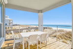 The covered deck offers shade and a table for outdoor dining