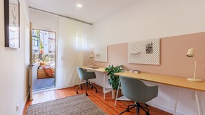 A simple and inviting office for two on the 1st floor with great natural light. Connect to a small back patio for a perfect workday escape. #CozyWorkspace #NaturalLightOffice