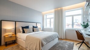 Modern bedroom with TV, small desk, comfortable chair, ample natural light, and balcony access for a serene and functional retreat.
#relax #bedroom