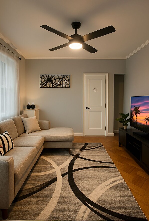 Cozy living room with smart TV and soft lighting to relax in style.