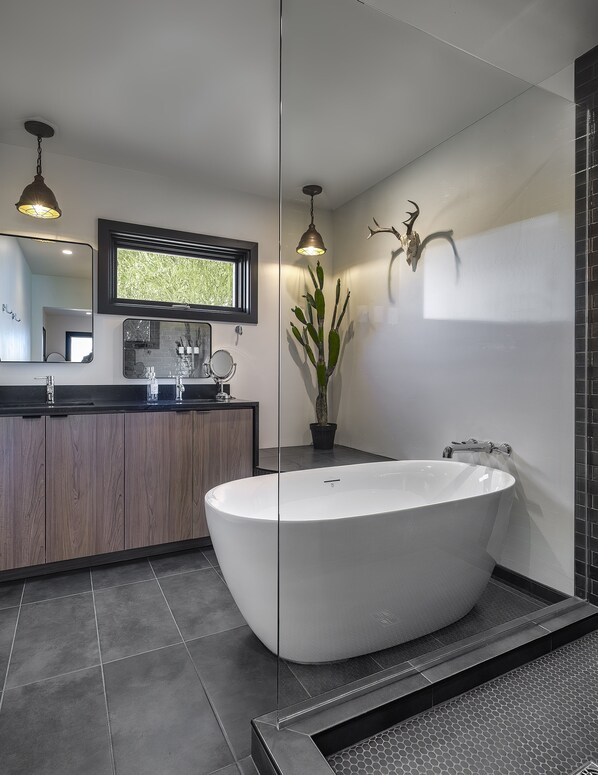 Step into the master bathroom at Tu'nlii House, where modern Southwest charm meets luxury. Indulge in a space thoughtfully designed with upscale amenities, creating a perfect blend of style and comfort for your rejuvenating retreat.