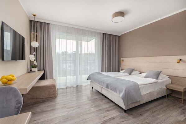 Bedroom with double bed, soft lighting, and beige decor for a calming atmosphere.
