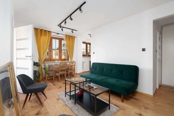 Living room with a double sofa bed, TV and dining area