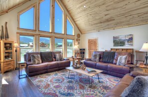 Main living space MountainAire VRC Rental Home - The bright living room showcases the custom Amish built cabin with mountain views from every window.