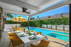 Enjoy dining alfresco under the shade of the wood canopy & cool misting system