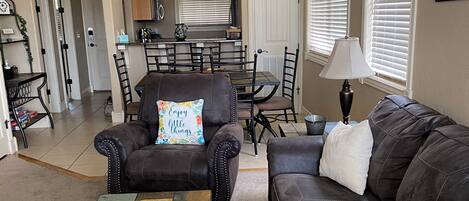 spacious living room with with fold out full size bed couch bed.