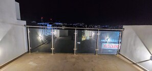 Nighttime city view from shared top floor terrace