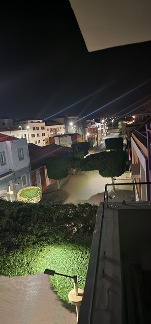 Nighttime city view from private balcony