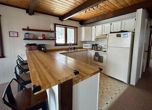 Kitchen with bar stools. 