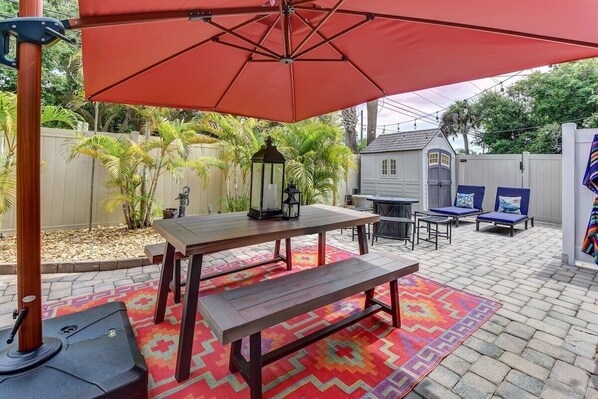 Private Fenced String-Lit Yard with Dining Table and Fire Pit