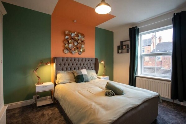 Cozy bedroom featuring a comfortable double bed, perfect for a restful night’s sleep.