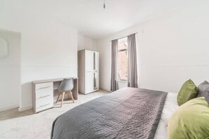 Cozy bedroom 1 featuring a comfortable double bed, perfect for a restful night’s sleep.