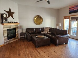 Living Room w/Leather Furniture, Gas Fireplace and French Doors to the Back Yard