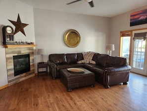 Living Room w/Leather Furniture, Gas Fireplace and French Doors to the Back Yard