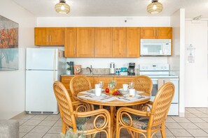 Fully equipped kitchen with full size appliances, and dining table with 4 chairs.