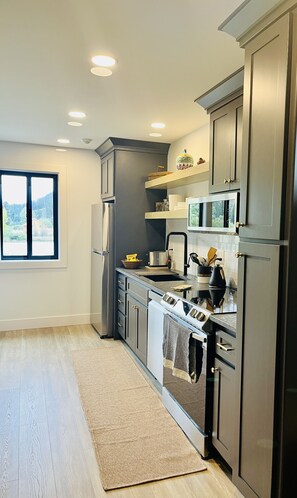 Spacious kitchen completely stocked for cooking