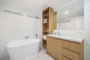 Modern bathroom with spacious shower & separate bath.