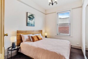Retreat to the serene primary bedroom, boasting a king-size bed. 