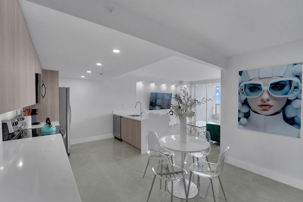 Dining area, fully equipped kitchen, living area with Roku tv, balcony access
