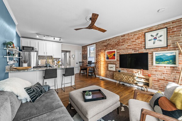 Open Concept Entry, Living Room, Kitchen, and Dining Space - Beautiful Exposed Brick Wall