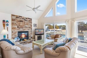 Relax in the Living Area with a Wall of Windows to the Water.