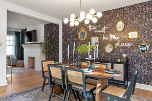 Dine in style against the backdrop of an intriguing wallpaper in the dining area