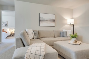 Inviting family room with spacious L-shaped sectional and an oversized ottoman, perfect for gatherings and relaxation.