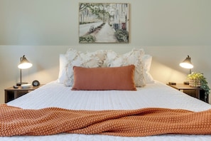 Spacious bedroom with a queen-sized bed, memory foam mattress, and luxury linens and pillows for a restful stay.