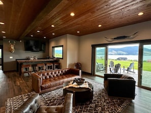 The downstairs den is your spot to unwind - complete with a wood burning fireplace and a four-stool bar with prep sink and cooler.