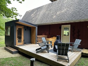 Sauna, outdoor shower, bathtub and sitting area behind the main house.