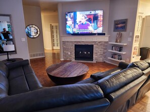 Comfy family room: Smart TV, gas fireplace for warmth & ambiance.