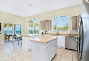 Large Open Windows in the Kitchen Close to the Dining Areas